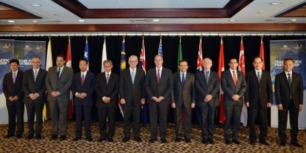A family photo shows trade ministers from the Trans-Pacific Partnership (TPP), a pan-Pacific trade agreement from 12 nations (L-R) Lim Jock Hoi from Brunei Darussalam, Ed Fast from Canada, Andres Rebolledo from Chile, Akira Amari from Japan, Sri Mustapa Mohamed of Malaysia, Andrew Robb from Australia, Mike Froman from the US, Ildefonso Guajardoform Mexico, Tim Groser from New Zealand, Jorge Del Castillo from Peru, Lim Hng Kiang from Singapore and Tran Quoc Khanh from Vietnam, in Sydney on October 26, 2014. The TPP, which would encompass 40 percent of the global economy and include 12 nations, has been the subject of negotiations for years. AFP PHOTO/Peter PARKS (Photo credit should read PETER PARKS/AFP/Getty Images)