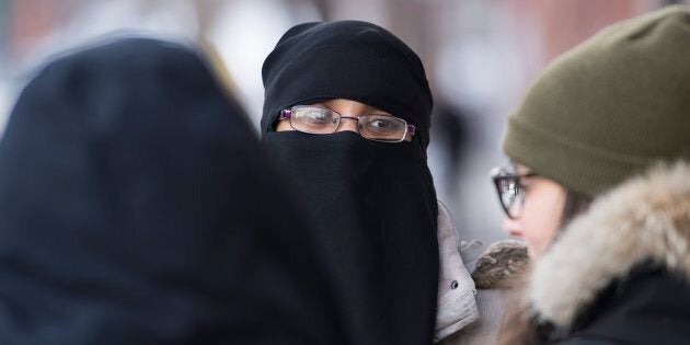 People rally outside the Khadijah Islamic centre in Montreal on Feb. 3, 2017, in a show of support after vandals broke a window and pelted the building with eggs.