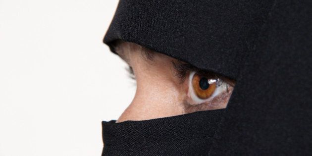 Symbol photo Islam. Muslim woman is veiled with a Burqa.