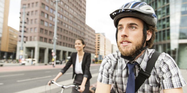 Man and woman commuting with bicycle.