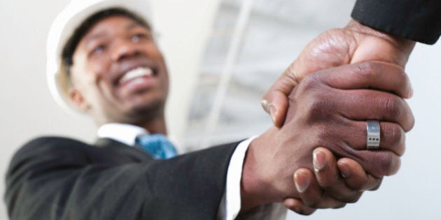 Low angle view of a building contractor shaking hands, South Africa