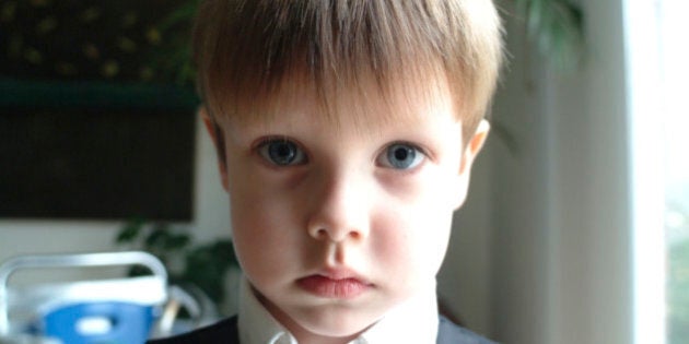 Canada, Toronto, Portrait of serious boy (8-9) indoors