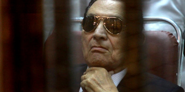 FILE-- In this Saturday, April 26, 2014 file photo, ousted Egyptian President Hosni Mubarak attends a hearing in his retrial over charges of failing to stop killings of protesters during the 2011 uprising that led to his downfall, in the Police Academy-turned-court in the outskirts of Cairo, Egypt. On Wednesday, May 21, 2014 an Egyptian court has convicted ousted President Hosni Mubarak of embezzlement and sentenced him to three years in prison. Mubarak's two sons, one-time heir apparent Gamal and wealthy businessman Alaa, were also convicted of graft and sentenced to four years in prison each. (AP Photo/Tarek el Gabbas, File)