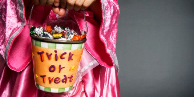 Girl holding Halloween trick or treat bucket