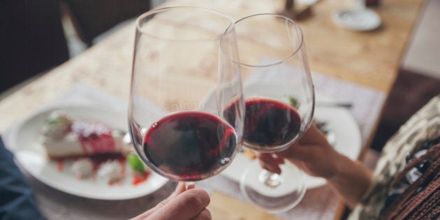 Couple toasting with wine in cafe