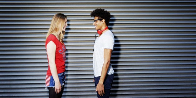 young man facing young woman