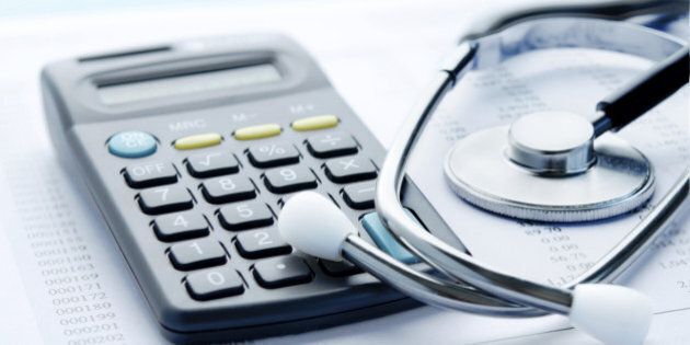 Stethoscope and calculator symbol for health care costs or medical insurance