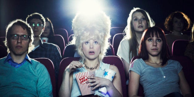 Woman enjoying movie at cinema