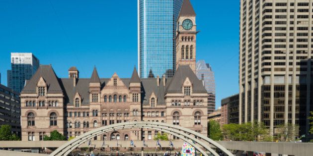 TORONTO, ONTARIO, CANADA - 2015/05/23: Old city hall from across Nathan Phillips Square, against a backdrop of a modern buildings and a bright blue sky, gothic architecture juxtaposed with the contemporary elements. (Photo by Roberto Machado Noa/LightRocket via Getty Images)