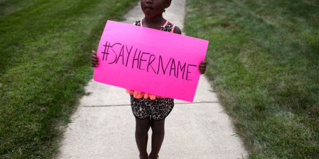 LISLE, IL - JULY 25: Daija Belcher, 5, holds a sign in front of the DuPage African Methodist Episcopal Church during the funeral service for Sandra Bland on July 25, 2015 in Lisle, Illinois. Bland's death roused suspicion nationwide after the 28-year-old was found hanging from a plastic bag three days after she was pulled over by a Texas State Trooper for a traffic violation. (Photo by Jonathan Gibby/Getty Images)
