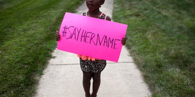 LISLE, IL - JULY 25: Daija Belcher, 5, holds a sign in front of the DuPage African Methodist Episcopal Church during the funeral service for Sandra Bland on July 25, 2015 in Lisle, Illinois. Bland's death roused suspicion nationwide after the 28-year-old was found hanging from a plastic bag three days after she was pulled over by a Texas State Trooper for a traffic violation. (Photo by Jonathan Gibby/Getty Images)