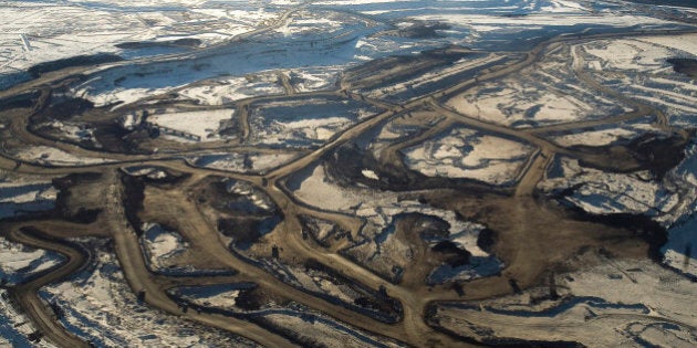 FORT MCMURRAY, ALBERTA, CANADA - NOVEMBER 2008: Aerial views of the mines of Syncrude Canada Ltd and Suncor Energy Inc. Tar sands, or oil sands, are very dense and contain a form of petroleum The world's largest reserves of tar sands in Canada and Venezuela. Tar sands could equate to approximately two thirds of the total global petroleum resource. Until recently it was financially not viable to extract the oil from the sands, but new technology and rising oil prices have now made it viable. (Photo by Veronqiue de Viguerie/Getty Images)