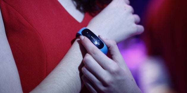 An employee demonstrates a Talkband wearable device during a Huawei Technologies Co. news conference ahead of the Mobile World Congress in Barcelona, Spain, on Sunday, Feb. 23, 2014. Top telecommunication managers will rub shoulders in Barcelona next week at the Mobile World Congress, Monday, Feb. 24 - 27, a traditional venue for showcasing the latest products for dealmaking. Photographer: Simon Dawson/Bloomberg via Getty Images