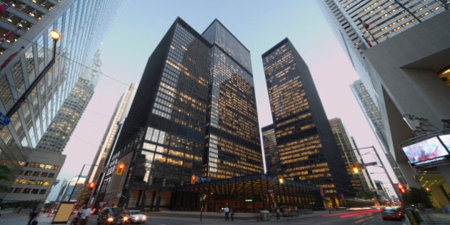 Corner of Bay Street and King Street at dusk in the Financial District of Toronto at dusk.