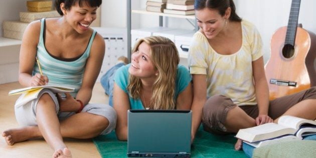 Multi-ethnic women studying on floor