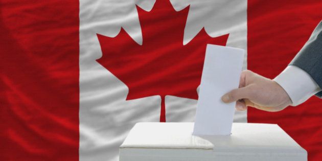 man putting ballot in a box during elections in canada