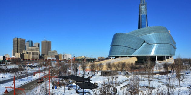 An urban cityscape of downtown Winnipeg, Manitoba under a big blue sky.