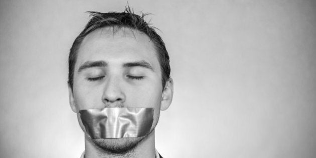 Photo of a young man with sellotape covering his mouth