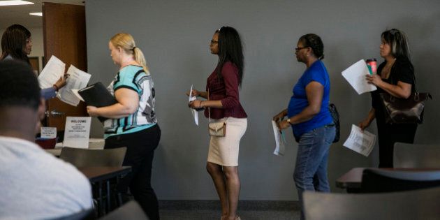 Job seekers wait in line to meet with representatives during a weekly job fair event in Dallas, Texas, U.S., on Wednesday, Sept. 2, 2015. Filings for U.S. unemployment benefits rose more than forecast to an eight-week high, representing a pause in a trend of more muted firings. Photographer: Laura Buckman/Bloomberg via Getty Images