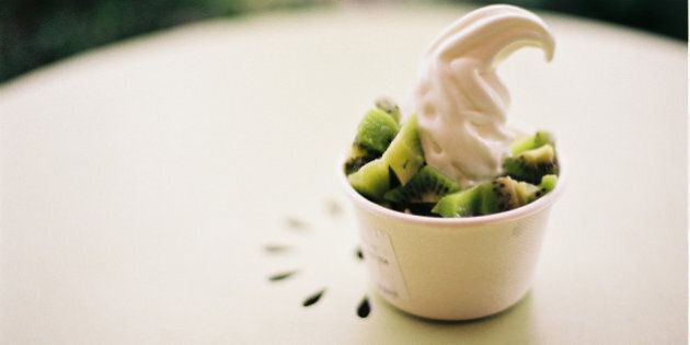 Close up of frozen yogurt with ice cream on it.