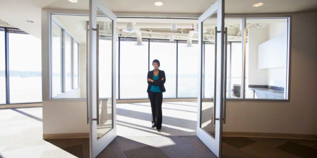 African American businesswoman standing in empty office