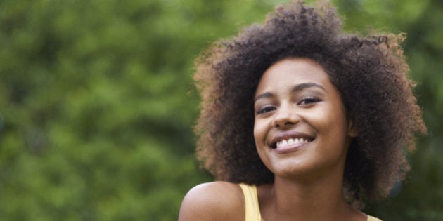 Portrait of a happy young woman outside in a garden