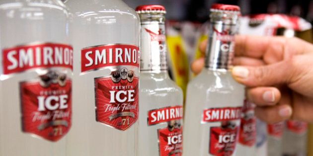 UNITED KINGDOM - FEBRUARY 12: A customers takes a bottle of Smirnoff Ice, a Diageo product, from the shelf at an off licence, in Hornchurch, U.K., on Thursday, Feb. 12, 2009. Diageo Plc, the world?s biggest liquor maker, signaled it may cut jobs and lowered its profit forecast as demand for Johnnie Walker whisky and Smirnoff vodka stalls, hurt by deteriorating economies around the world. (Photo by Chris Ratcliffe/Bloomberg via Getty Images)