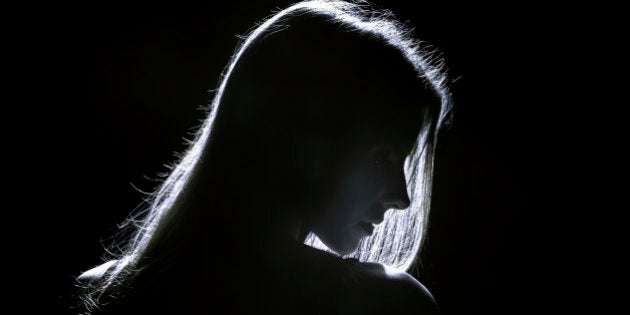 sad woman profile silhouette in dark