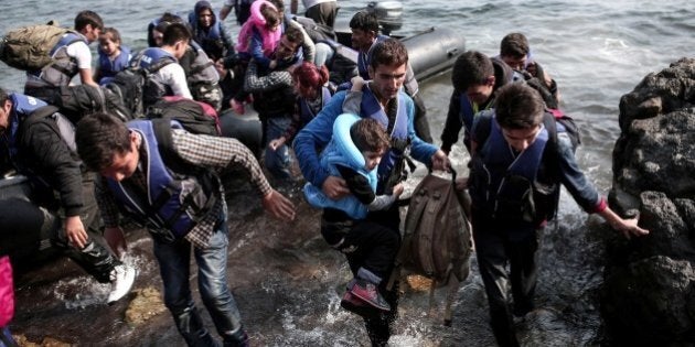 Syrian refugees land on the shores of the Greek island Lesbos in an inflatable dingy across the Aegean Sea from from Turkey on September 3, 2015. More than 230,000 refugees and migrants have arrived in Greece by sea this year, a huge rise from 17,500 in the same period in 2014, deputy shipping minister Nikos Zois said. AFP PHOTO / ANGELOS TZORTZINIS (Photo credit should read ANGELOS TZORTZINIS/AFP/Getty Images)