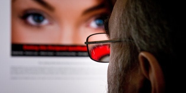 TO GO WITH AFP STORY US-LIFESTYLE-LOVE-INTERNET-ADULTERY BY FABIENNE FAURA man looks at a dating site on his computer in Washington,DC on February 10, 2014. One 29-year-old woman says it helped her take revenge on her unfaithful husband. A 45-year-old married man says it has helped prevent the break-up of his family. For millions, adultery via the Internet has become the new normal. Since the launch of the Canada-based Ashley Madison website in 2002, which created a sensation with its seductive slogan 'Life is short, have an affair,' the numbers turning to online infidelity have soared. There are now dozens of similar websites offering the promise of extramarital relationships with domain names that are unabashedly direct, from www.datingforcheaters.com to www.heatedaffairs.com. For Noel Biderman, the founder of Ashley Madison, his site and others like it are merely facilitating a human desire that is as old as time. AFP PHOTO/EVA HAMBACH (Photo credit should read EVA HAMBACH/AFP/Getty Images)