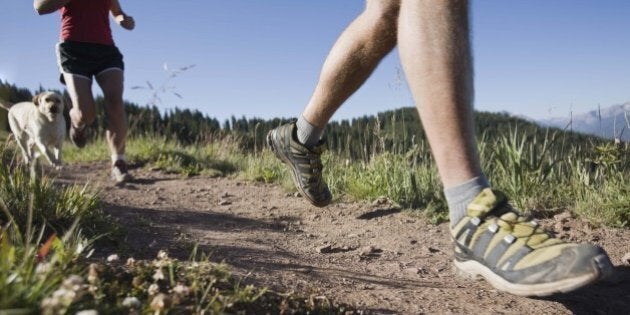 People running along path on hillside