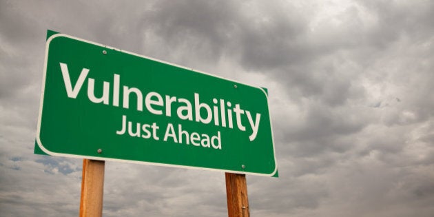 Vulnerability Just Ahead Green Road Sign with Dramatic Storm Clouds and Sky.