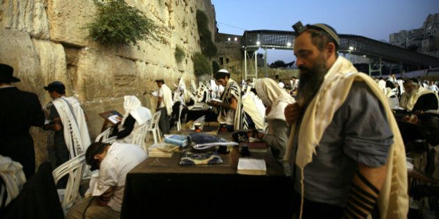 JERUSALEM, ISREAL - SEPTEMBER 2: Jews praying in front of the Wailing Wall on September 2, 2013 in Jerusalem. The Rosh Hashanah 2013, literally the head of the year in Hebrew, is celebrated on September 5-6 by the Jews with special ceremonies. (Photo by Awad Awada/Anadolu Agency/Getty Images)