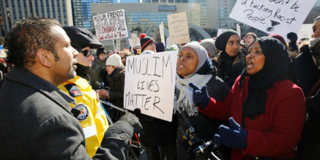 TORONTO, ON -March 04.Anti Hate and anti immigration protesters are separated by police at the Bill M103 protests at the Nathan Phillips Square (Rene Johnston/Toronto Star via Getty Images)