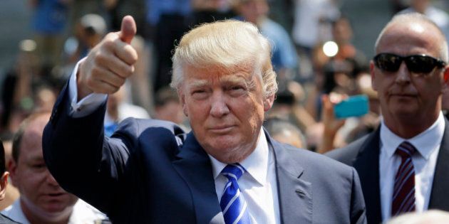 Donald Trump gives a thumbs-up as he leaves for lunch after being summoned for jury duty in New York, Monday, Aug. 17, 2015. Trump was due to report for jury duty Monday in Manhattan. The front-runner said last week before a rally in New Hampshire that he would willingly take a break from the campaign trail to answer the summons. (AP Photo/Seth Wenig)