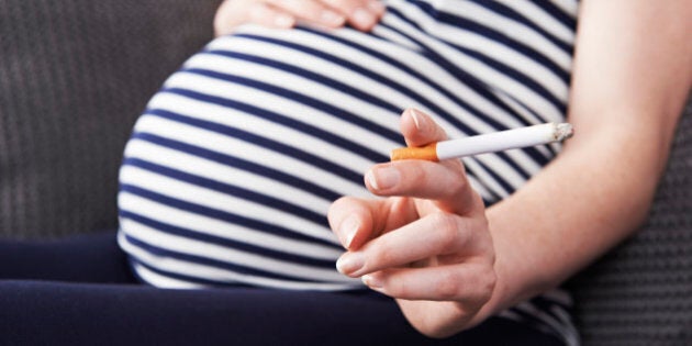 Close Up Of Pregnant Woman Smoking Cigarette