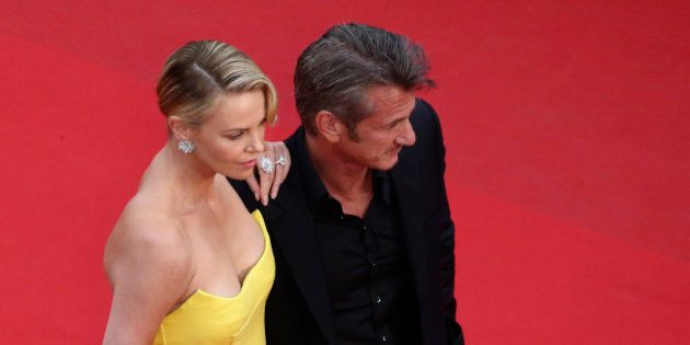 Actors Sean Penn, right, and Charlize Theron pose for photographers as they arrive for the screening of the film Mad Max: Fury Road at the 68th international film festival, Cannes, southern France, Thursday, May 14, 2015. (AP Photo/Vianney Le Caer, Pool)