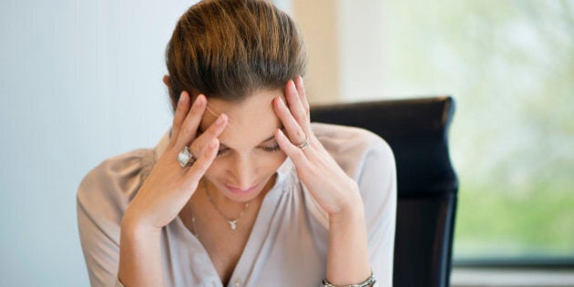 Close-up of a businesswoman suffering from a headache in an office