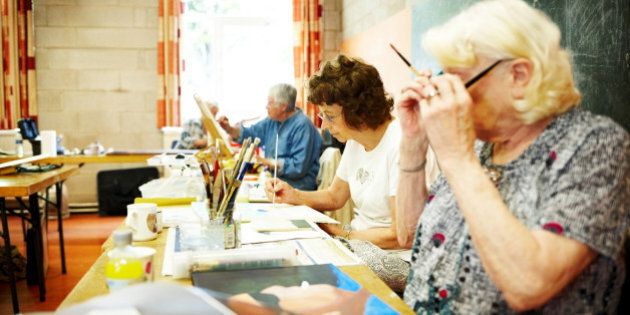 Image of senior women learning to paint in an art class
