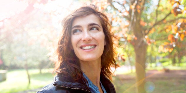 Girl smiling in autumn sun