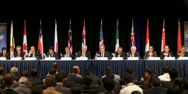 Ministers from 12 nations from left, Lim Jock Hoi from Brunei Darussalam, Ed Fast from Canada, Andres Rebolledo from Chile, Akira Amari from Japan, Sri Mustapa Mohamed of Malaysia, Andrew Robb from Australia, Mike Froman from the U.S., Ildefonso Guajardoform Mexico, Tim Groser from New Zealand, Jorge Del Castillo from Peru, Lim Hng Kiang from Singapore and Tran Quoc Khanh from Vietnam attend a press conference at the Trans-Pacific Partnership meeting in Sydney, Australia, Monday, Oct. 27, 2014. (AP Photo/Rob Griffith)