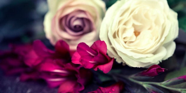 Antique rose and gladioli. Toned image with shallow focus.