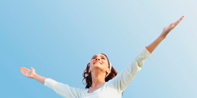 Young woman with arms outstretched