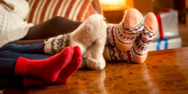 Closeup conceptual photo of family warming feet at fireplace