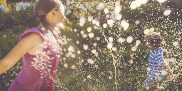 Little boy and girl playing with water