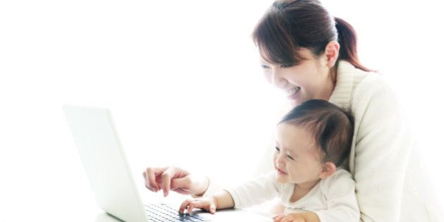 mother and baby using notebook PC