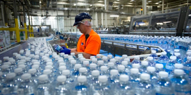 A worker inspects bottles of water at the Nestle Waters Canada plant near Guelph, Ontario, Canada, on Friday, Jan. 16, 2015. Nestle, the world's largest food company, owns about 60 water brands including Pure Life, the world's best-selling label. Photographer: Kevin Van Paassen/Bloomberg via Getty Images