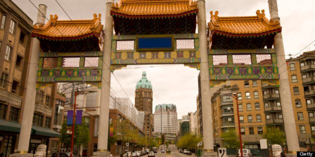 Pender Street leading through the Millennium Gate in Vancouver Chinatown with the Sun Tower in the background.
