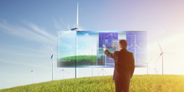 Mixed race businessman using touch screen computer outdoors