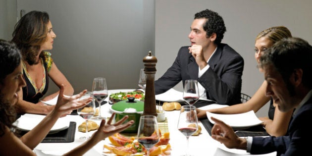 Group of people gathered around dinner table